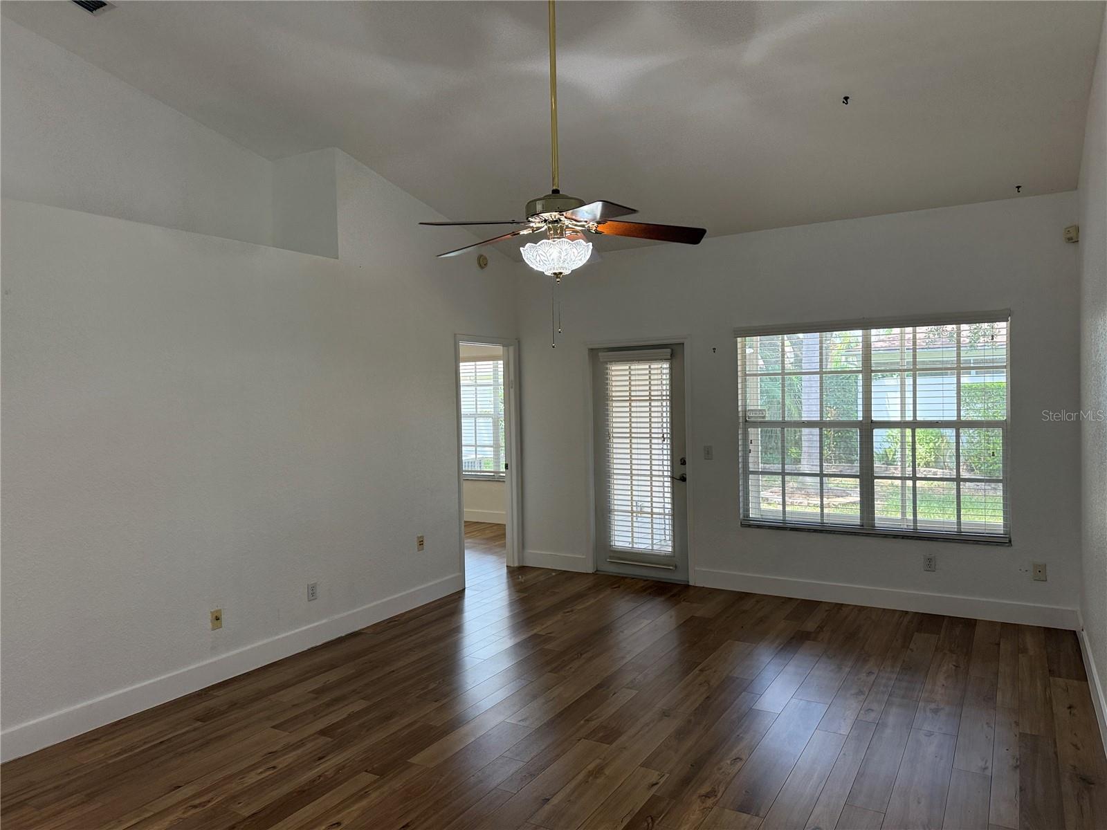 Living room with screened porch view to the north and the primary suite.