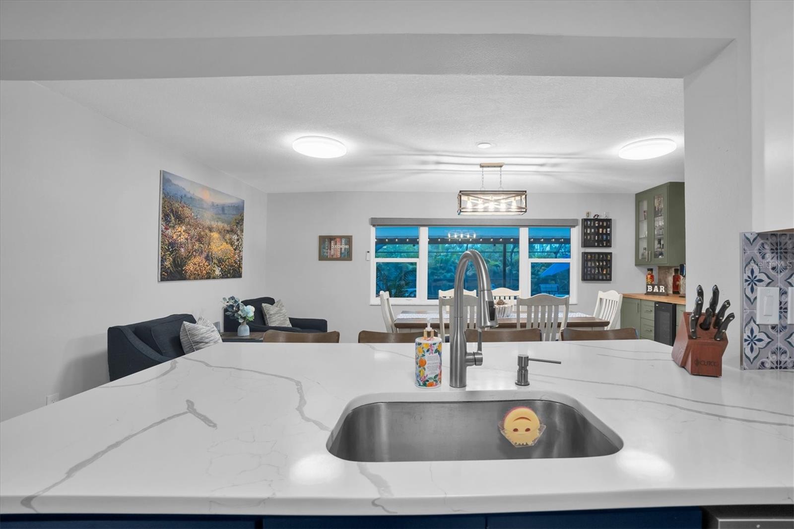 KITCHEN OPENS INTO DINING AREA AND VIEWS OF POOL BEYOND!