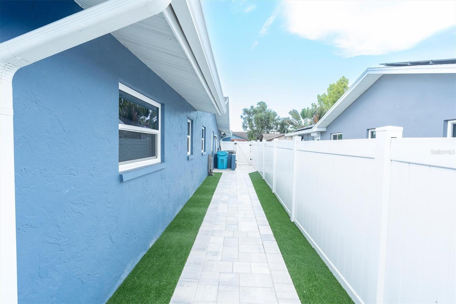 NEW PAVER PATH WITH NEW VINYL FENCING LEADING FROM FRONT OF HOME TO BACK TO DETACHED FLEX SPACE AND POOL AREA!