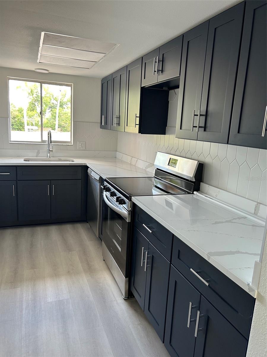 Lovely kitchen w/ window for natural light. All new appliances, countertops, flooring.