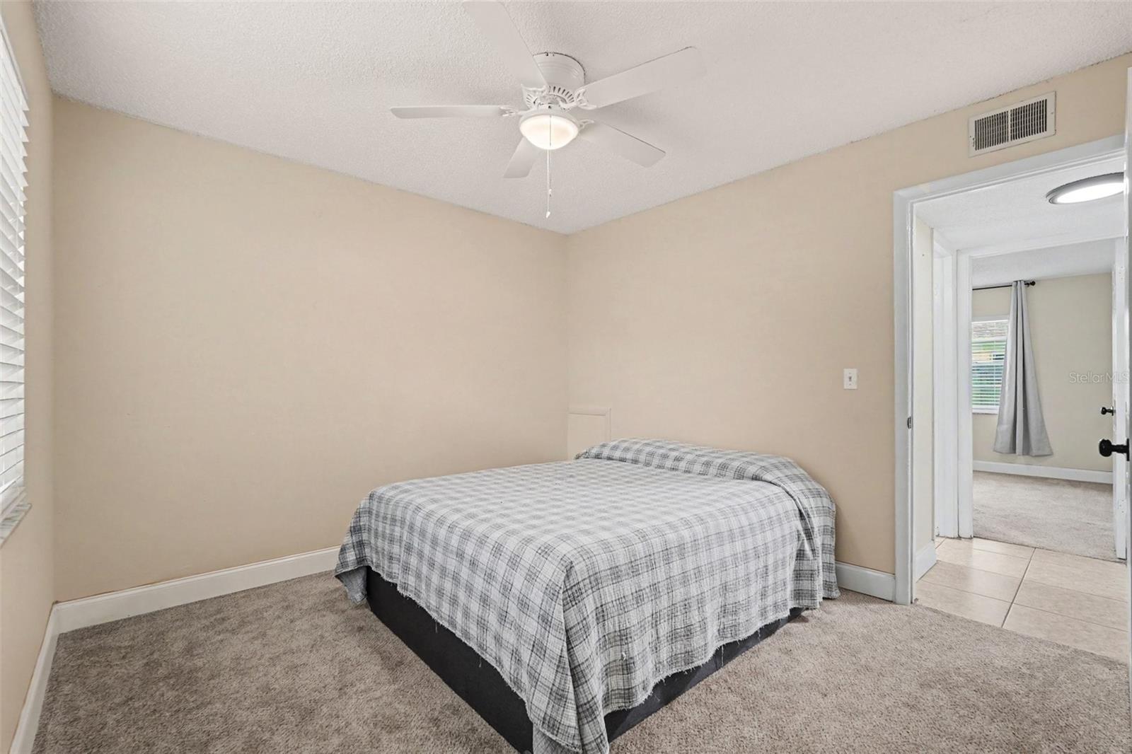 A comfortable secondary bedroom that's perfect for family, guests, or roommates.