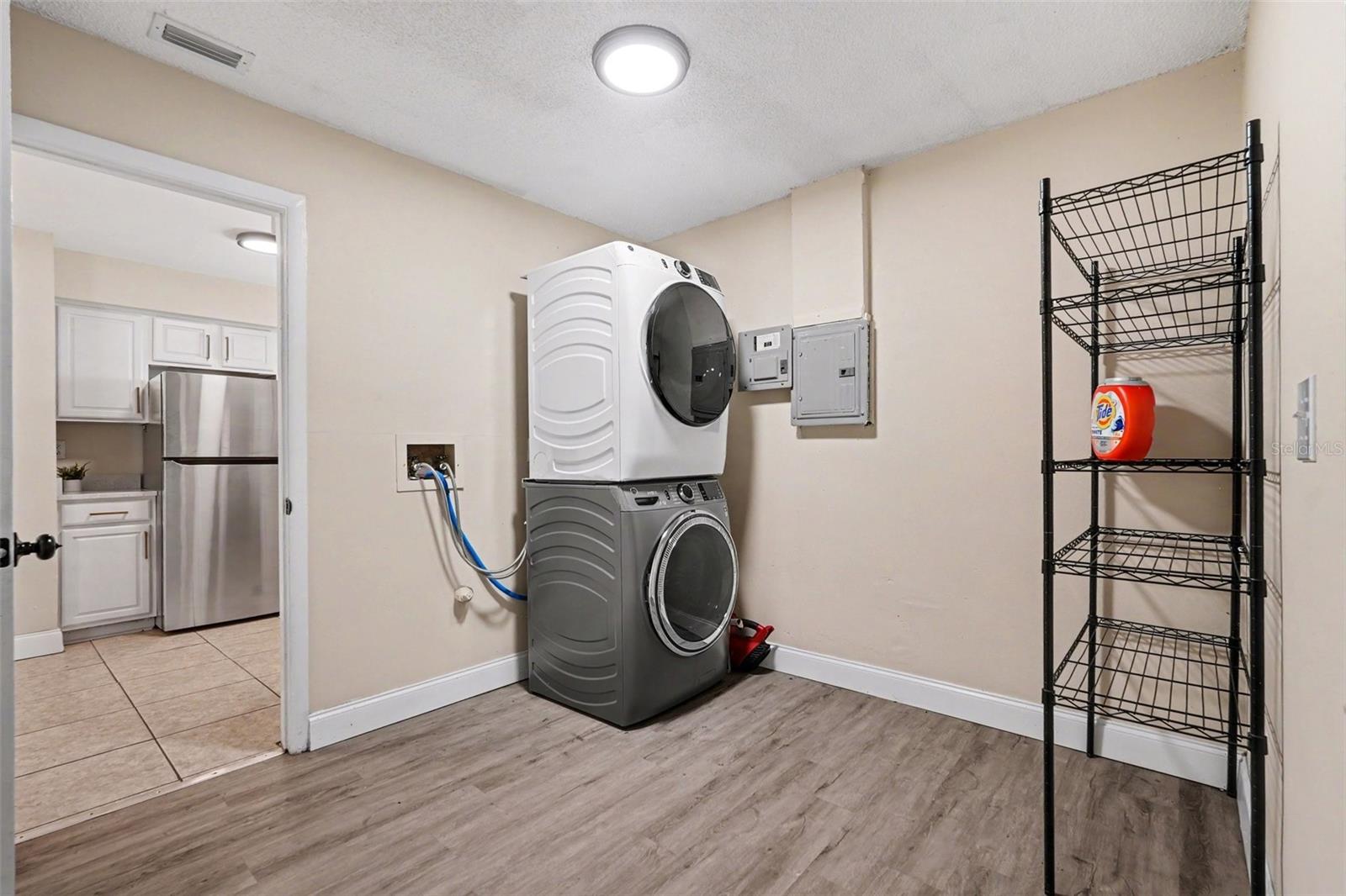 An oversized inside laundry room provides extra storage and everyday convenience.