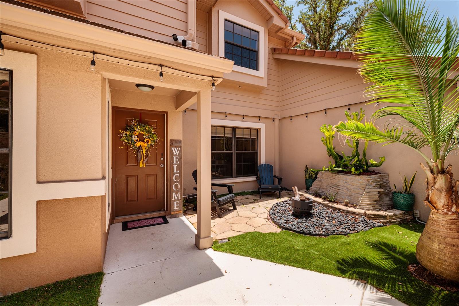 Front with patio, fire pit, and front door