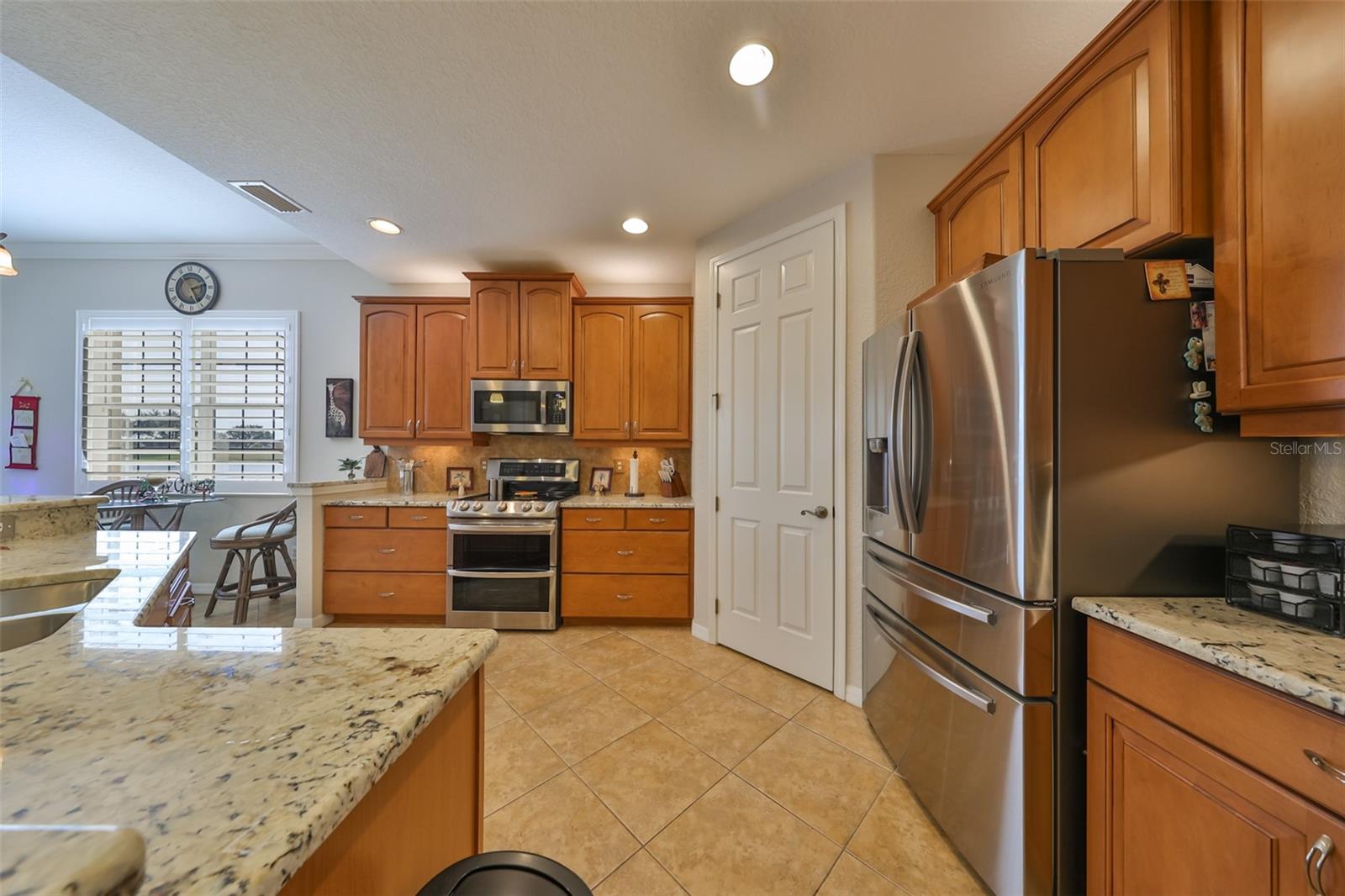 The open concept ensures that you are always a part of the action.  Notice the drawers next to the double oven and the bright lights for easy cooking.