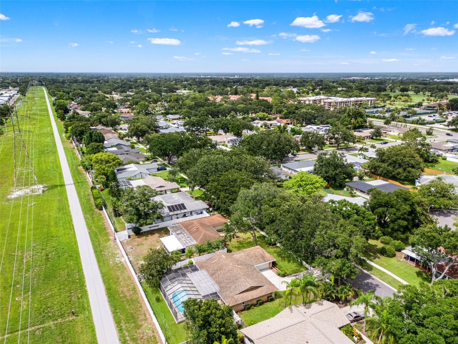 This aerial view reveals the property's proximity to the Duke Energy Trail, with direct, private access at the rear of the fenced yard for walking, biking, or an evening escape.