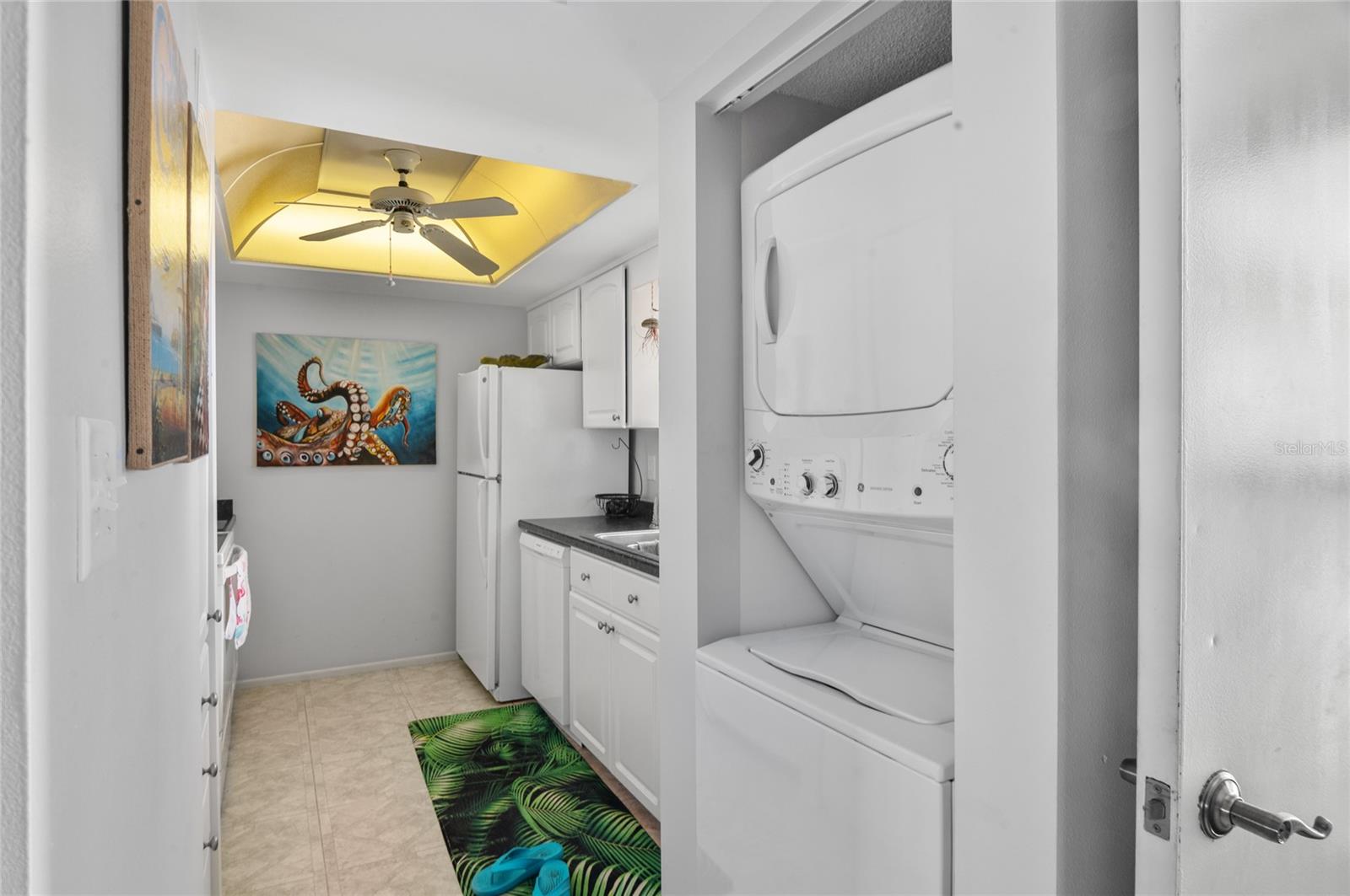 Kitchen features a FULL SIZEstacked washer and dryer