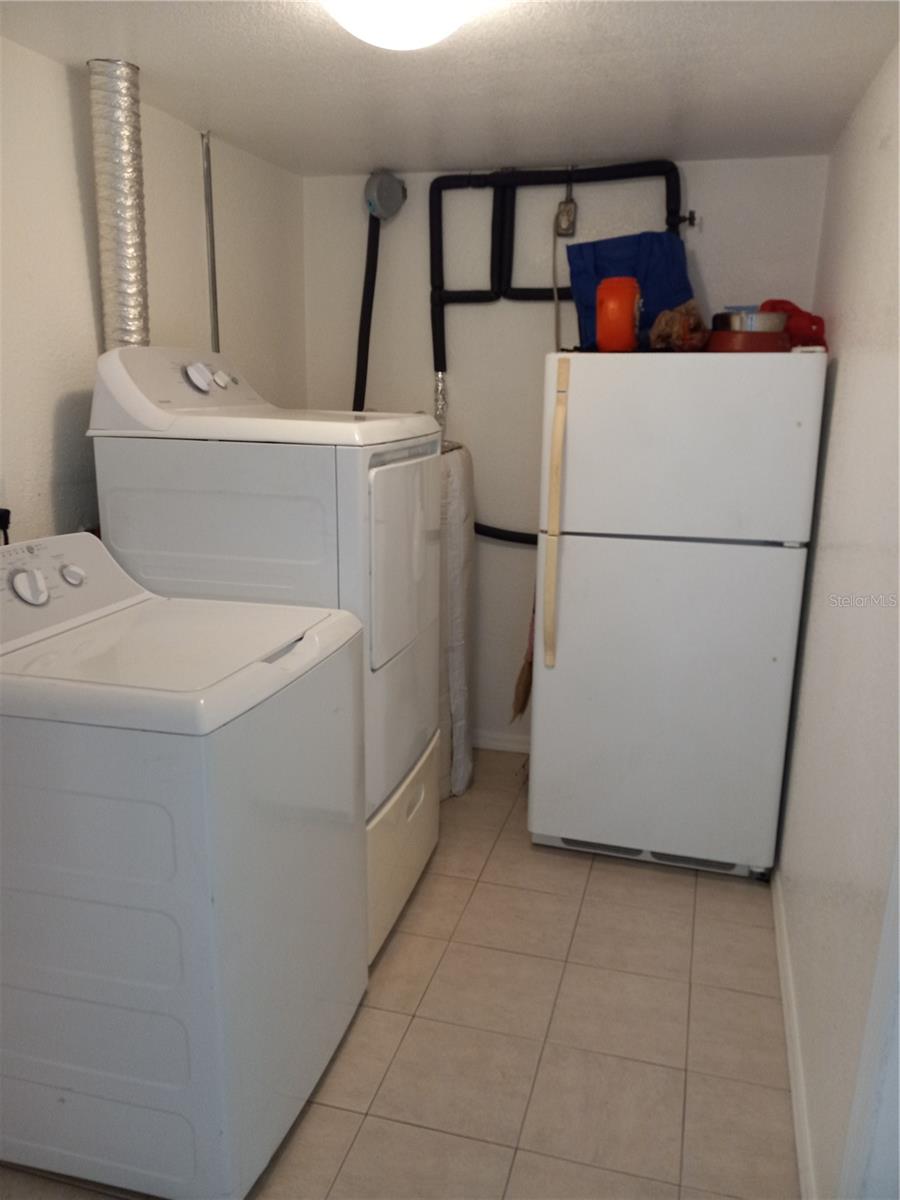 6 x 10 laundry room connects from garage to kitchen,  extra refrigerator stays