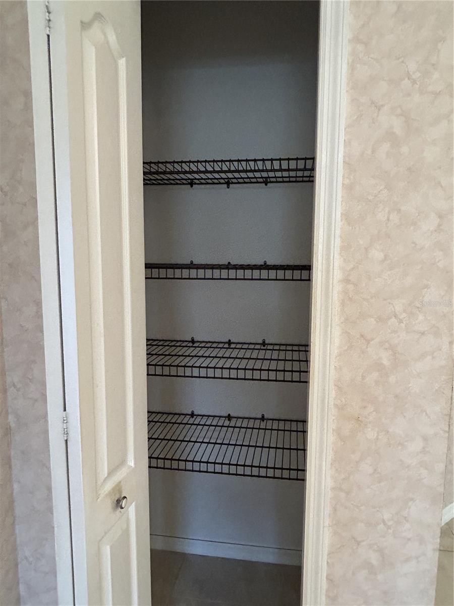 linen closet in primary bathroom