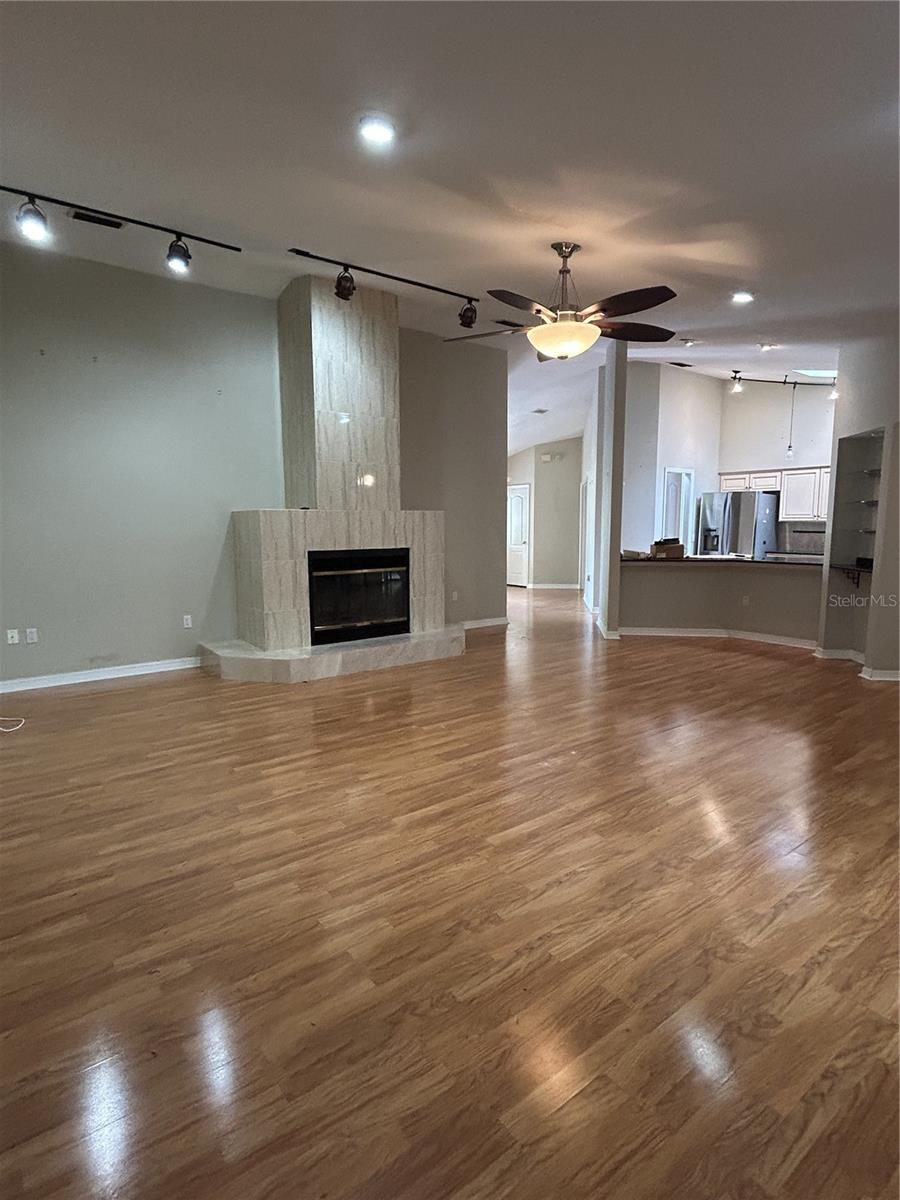 Spacious living room is the heart of the home has wood burning fireplace!