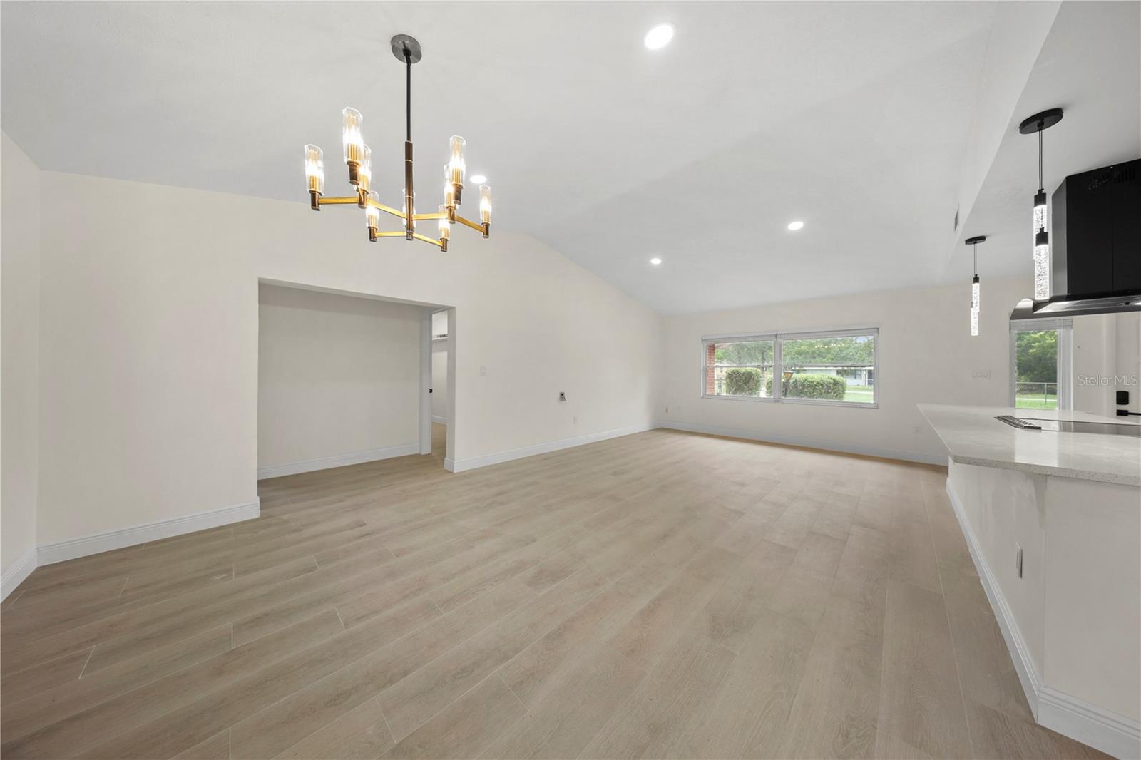 Hallway leads to patio access, Bedroom 3 on the left, and laundry room/garage access on the right.