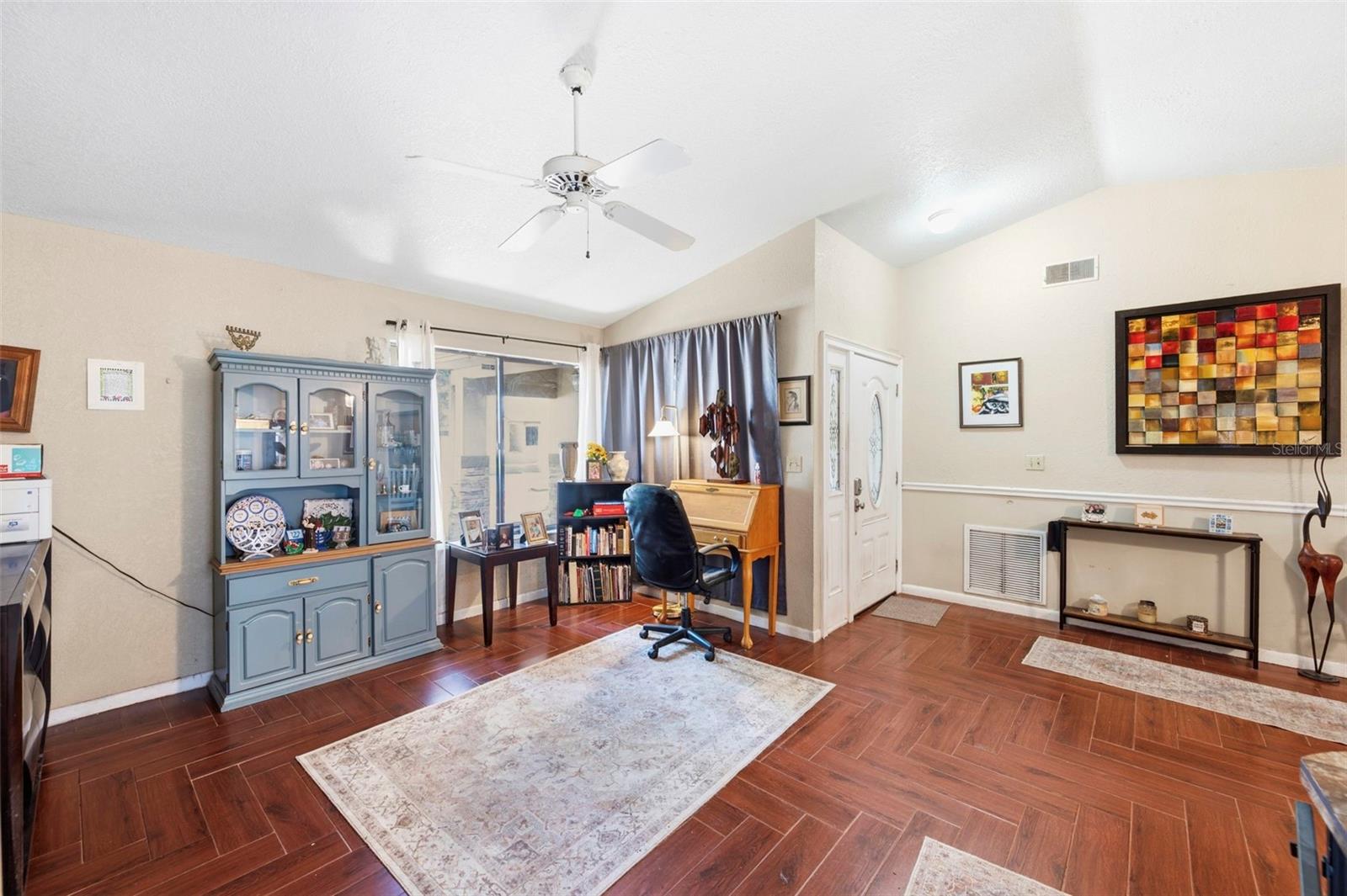 Living room with vaulted ceilings and chevron patterned tile floor