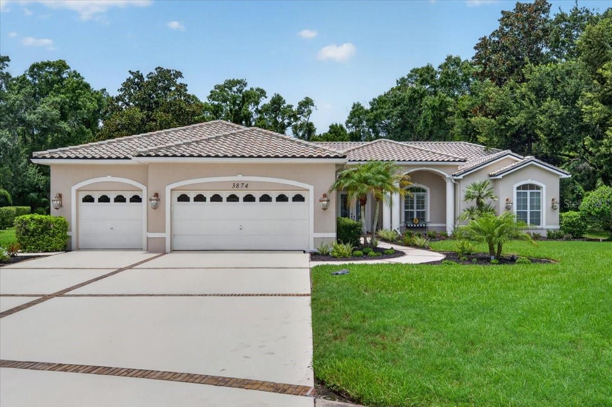 Welcome to 3874 Crescent Cove Place in Tarpon Springs. A custom-built and set on 3.3 acres along a quiet cul-de-sac, this four-bedroom plus office, four-bath pool home with a three-car garage backs to a peaceful preserve in the double-gated Regency section of Crescent Oaks.