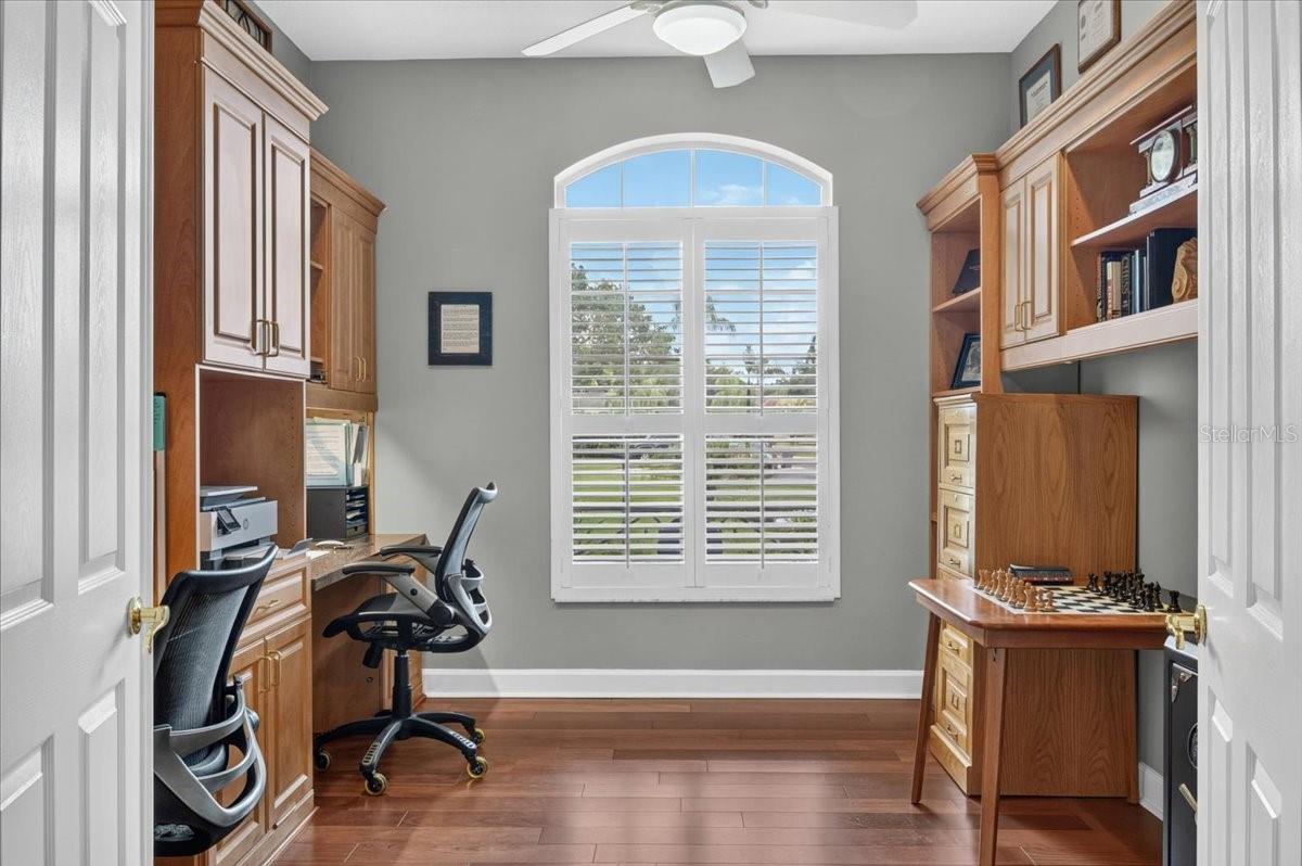 Near the front entry, the dedicated office features plantation shutters, built-in cabinetry and ample workspaces.