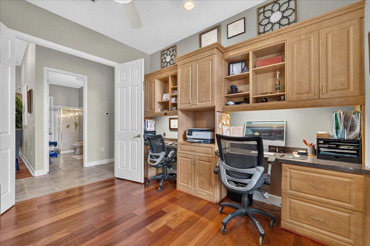 Near the front entry, the dedicated office features plantation shutters, built-in cabinetry and ample workspaces.