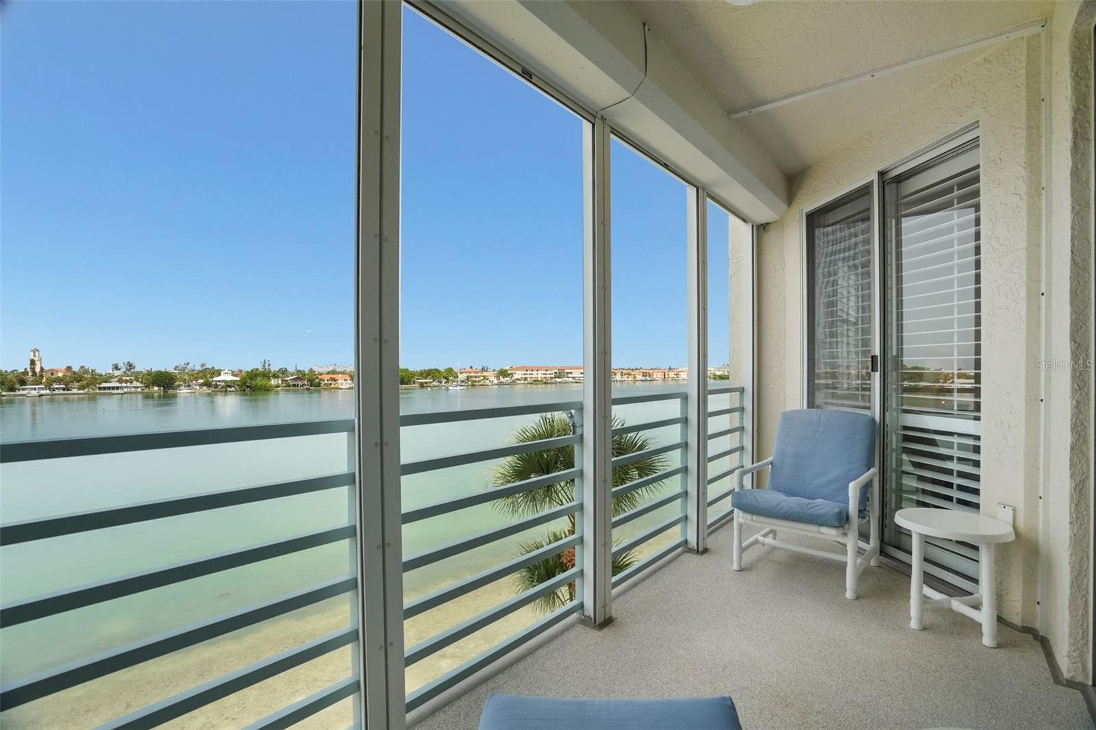 NICE SIZE BALCONY LEADING TO THE PRIMARY BEDROOM AND THE LIVING AREA.