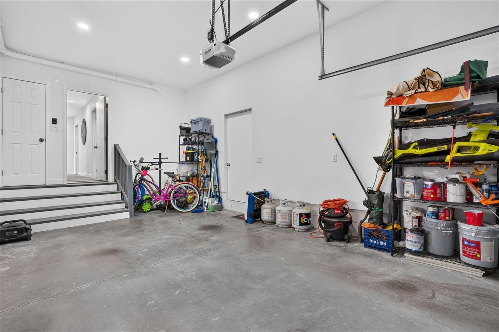 Garage with Extra high ceilings with additional storage room