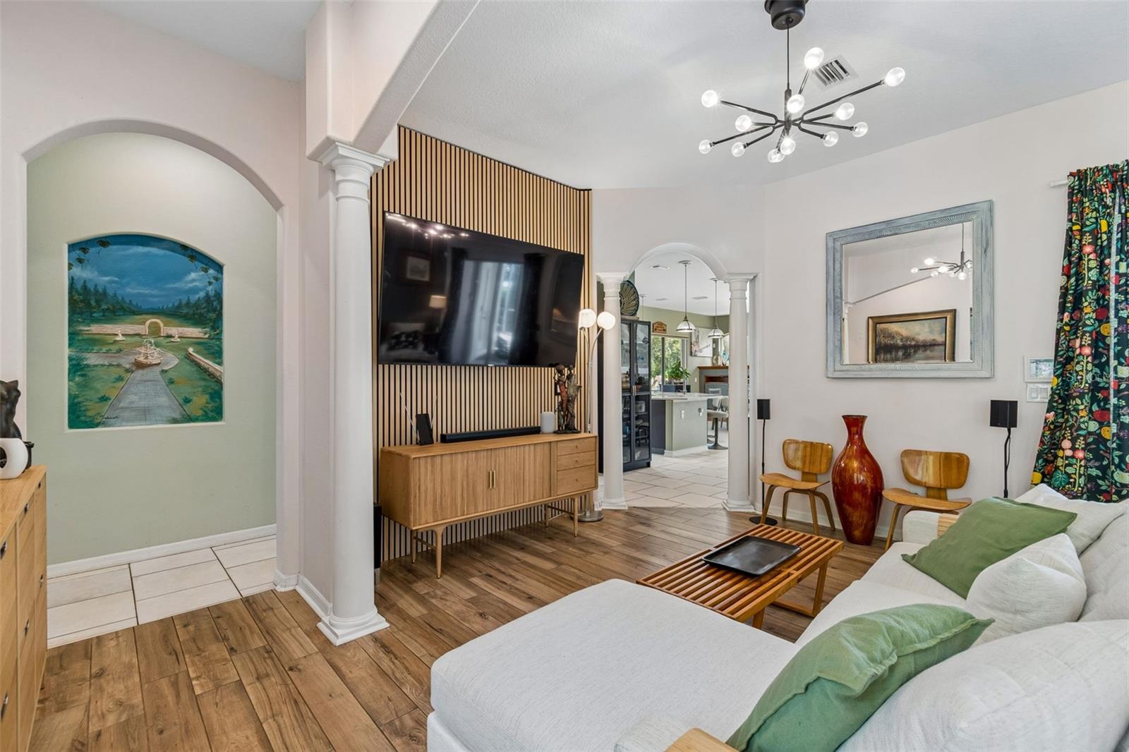 Formal Living Room has a natural White Oak Acoustic Slat Wood Panel to add both visual texture and sound absorption.
