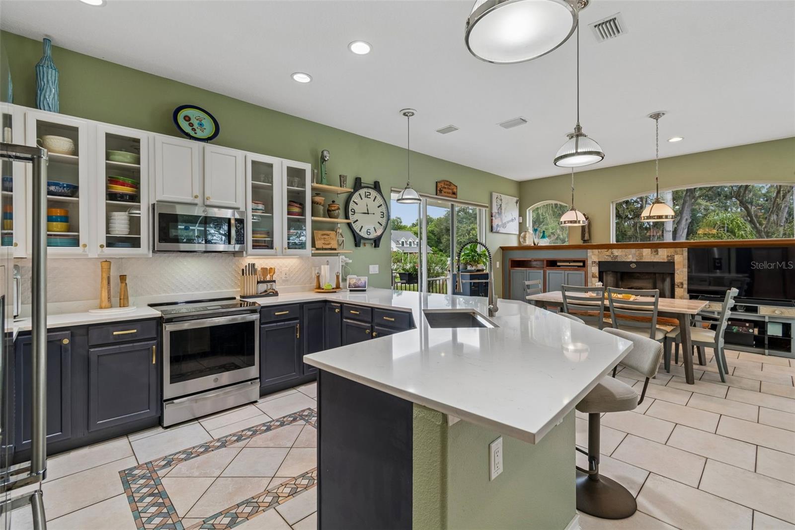 The Kitchen and Dining Room areas are a fabulous Gathering Space with Lots of light and doors to the pool & outdoor kitchen as well as a door to the courtyard and fire pit.