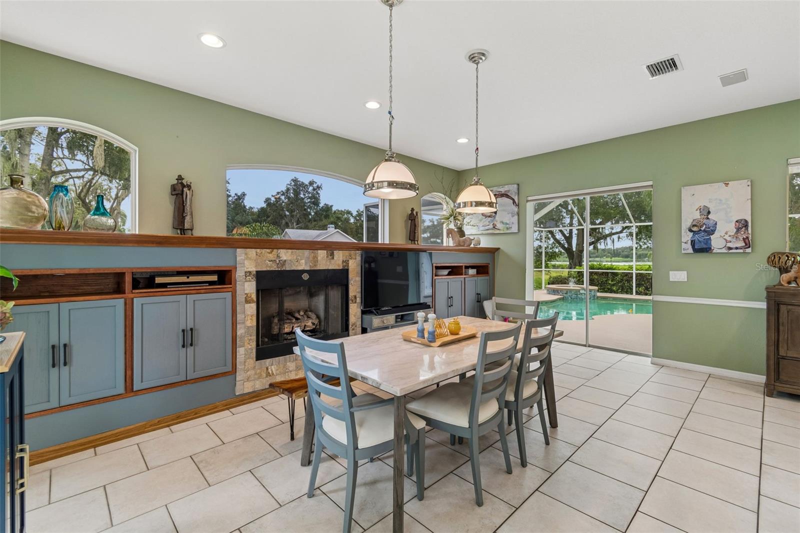 Double Sliders lead to the Pool and Outdoor Kitchen