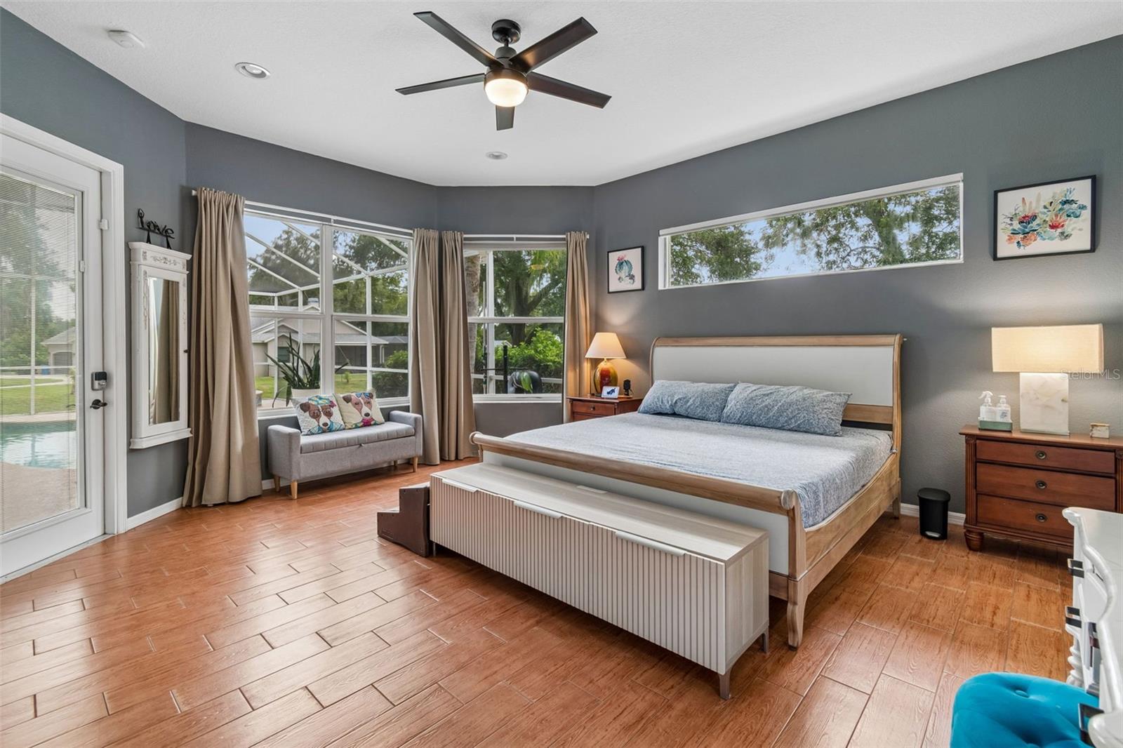 The 1st Floor Primary Suite is Spacious and Bright with a French Door that leads to the Pool.