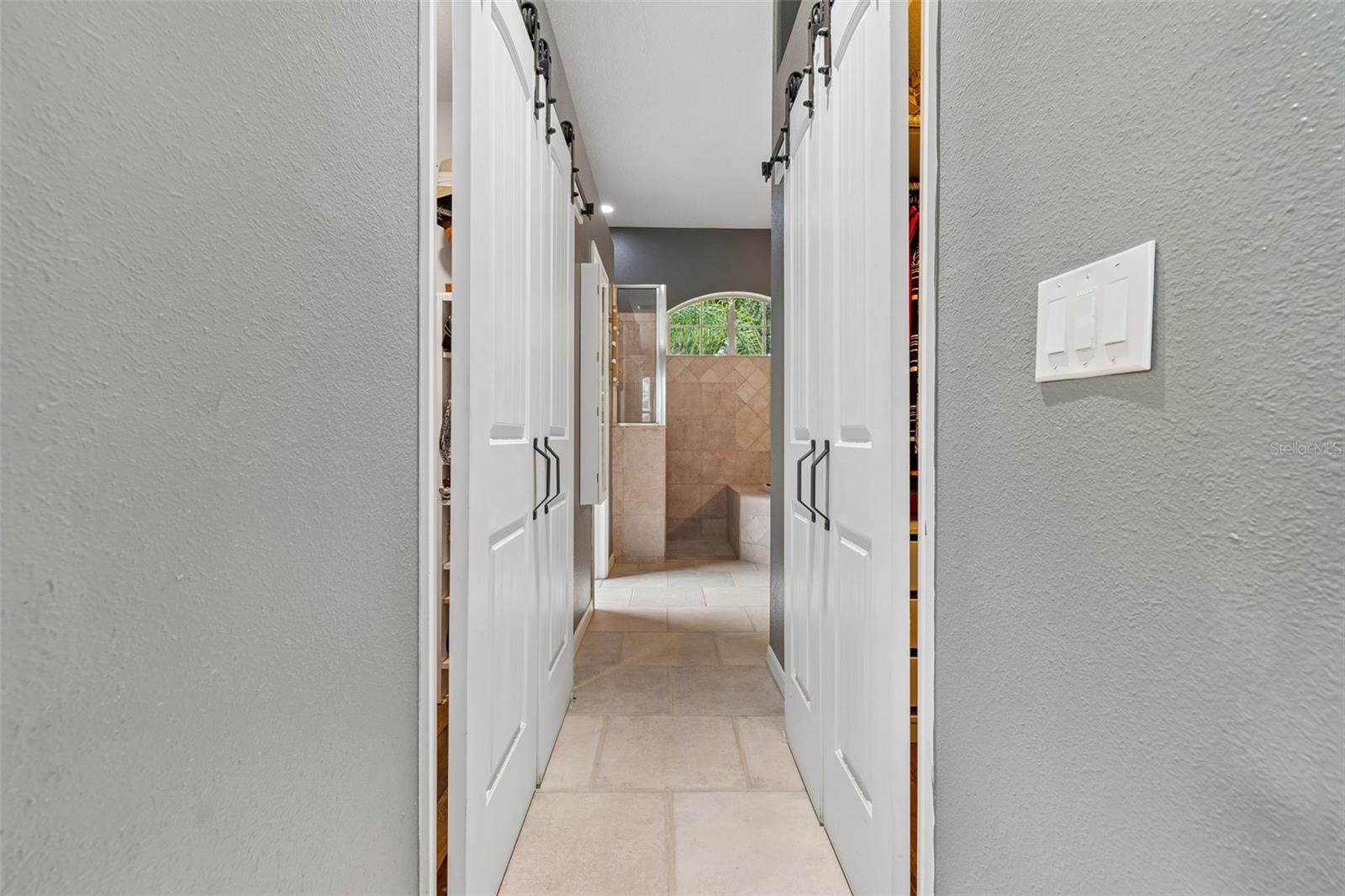The Primary Ensuite features walk-in Closets, Double Vanity, Custom Shower and Separate Tub, and Water Closet with more Storage and Shelves.