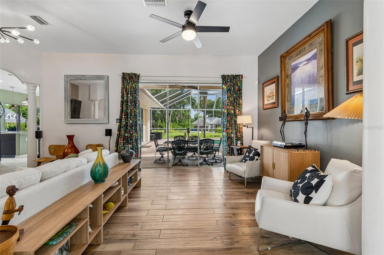 Living room with triple sliders to the pool & Outdoor Kitchen