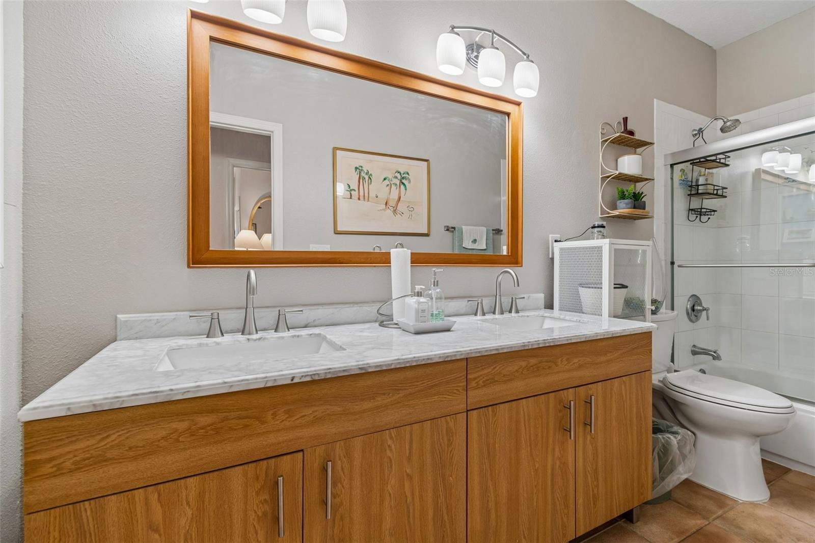 2nd Floor Guest Bath has been updated with Double Vanity and Tub with Shower and New Glass Shower Doors.
