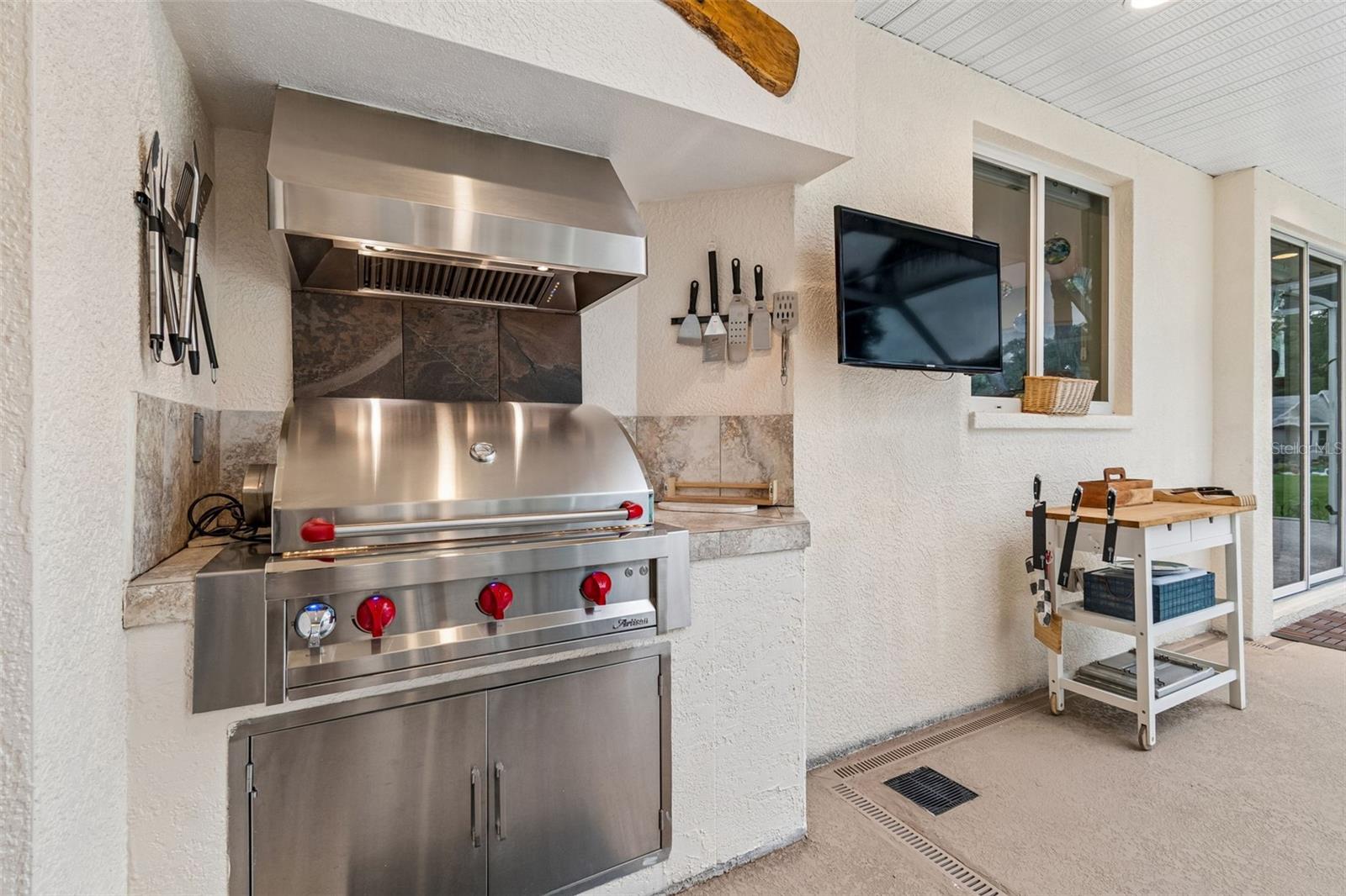 The outdoor kitchen area also has recessed Speakers and an outdoor Television that the Sellers are leaving for you.