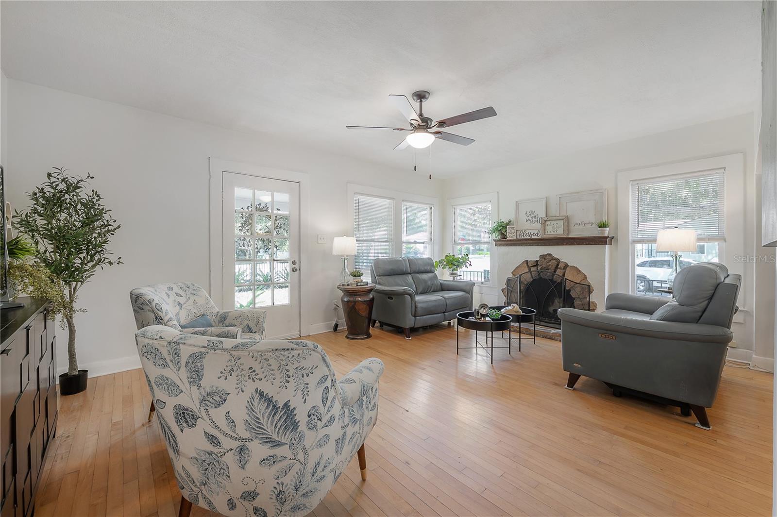 The spacious living room is exceptionally generous for a bungalow-style home and features a stylish wood-burning fireplace.