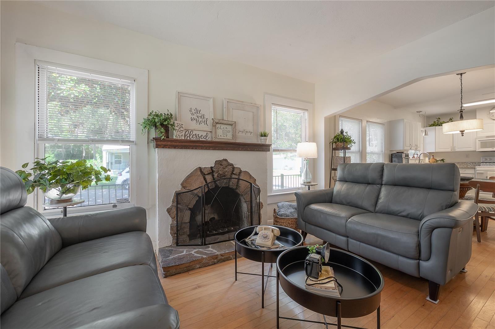 The spacious living room is exceptionally generous for a bungalow-style home and features a stylish wood-burning fireplace.