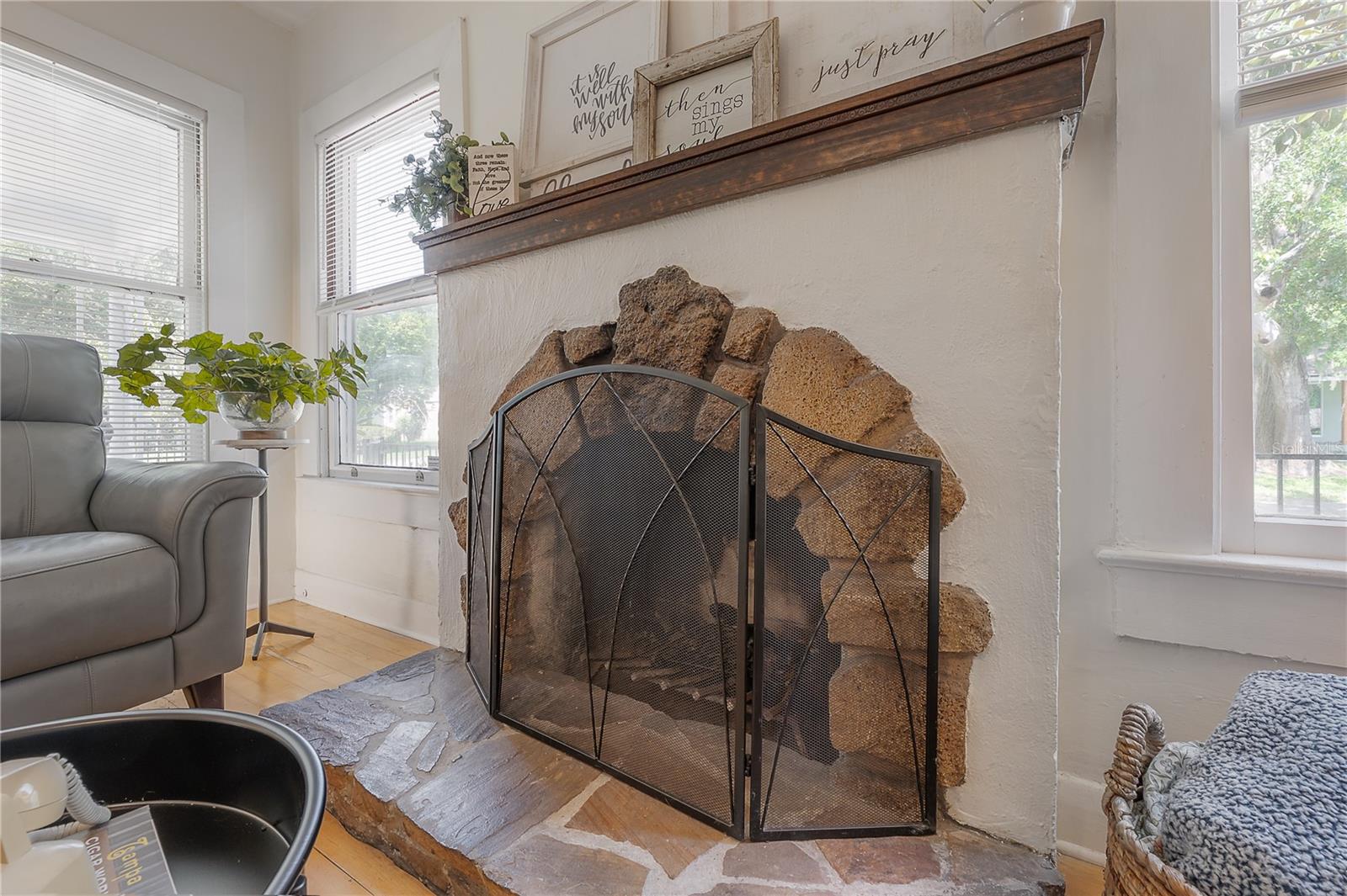The spacious living room is exceptionally generous for a bungalow-style home and features a stylish wood-burning fireplace.