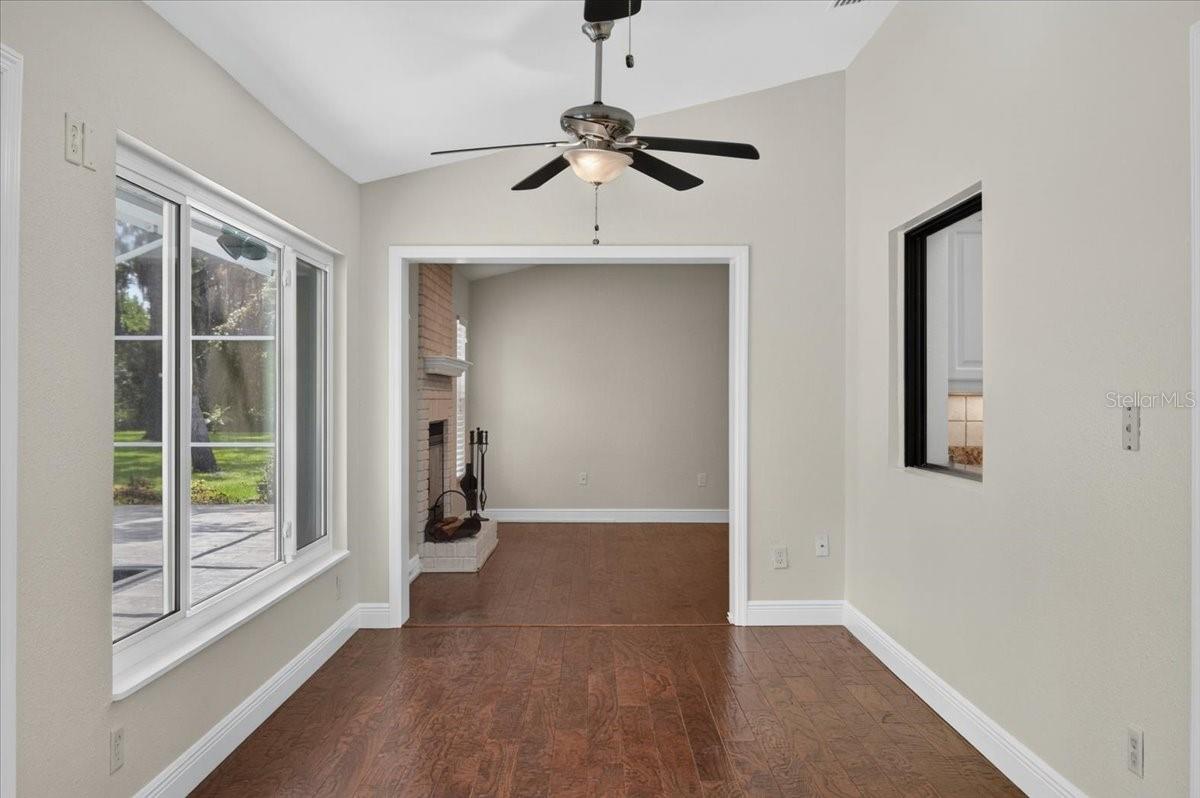 A pass-through connects the kitchen to the spacious Florida room, where walls of windows and impact sliding doors bring in views of the pool and expansive backyard.