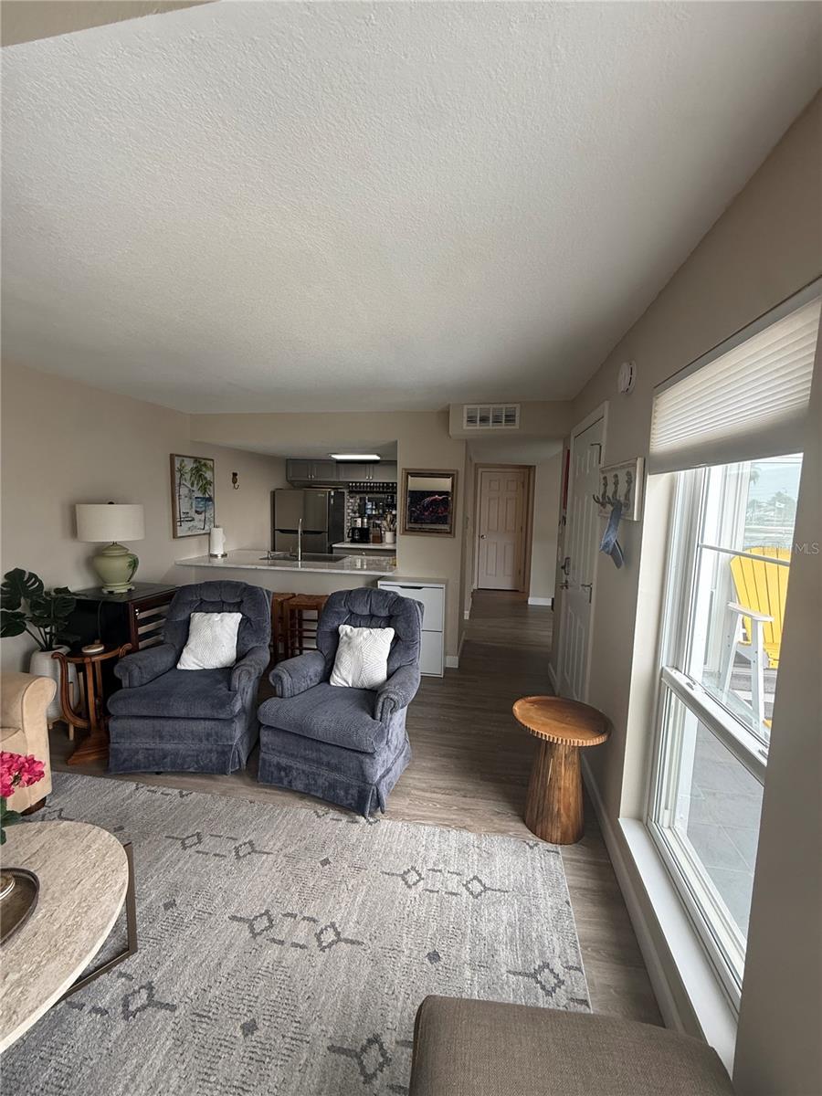 Living room leads to kitchen and dining room