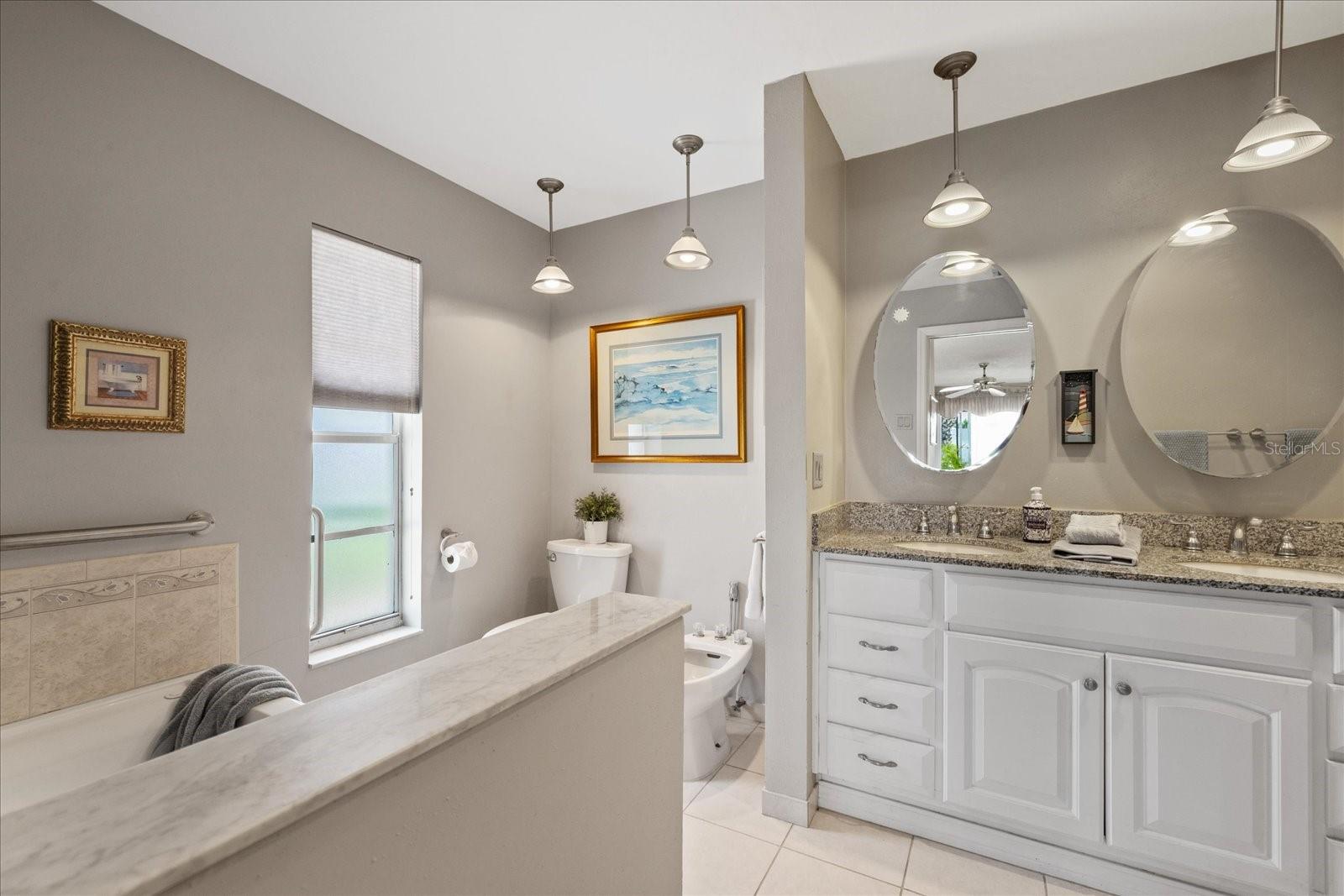 Primary en-suite with dual vanity, jetted garden tub, walk in shower and toilet and bidet. (bidet in not working)