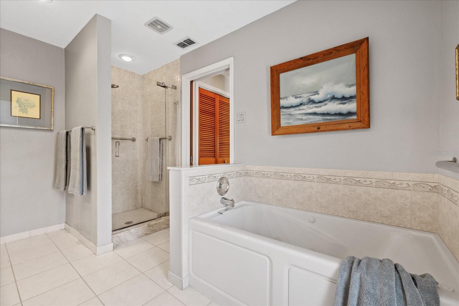 Primary ensuite with dual vanity, walk in shower, garden jetted tub, toilet and bidet.  (bidet not working)