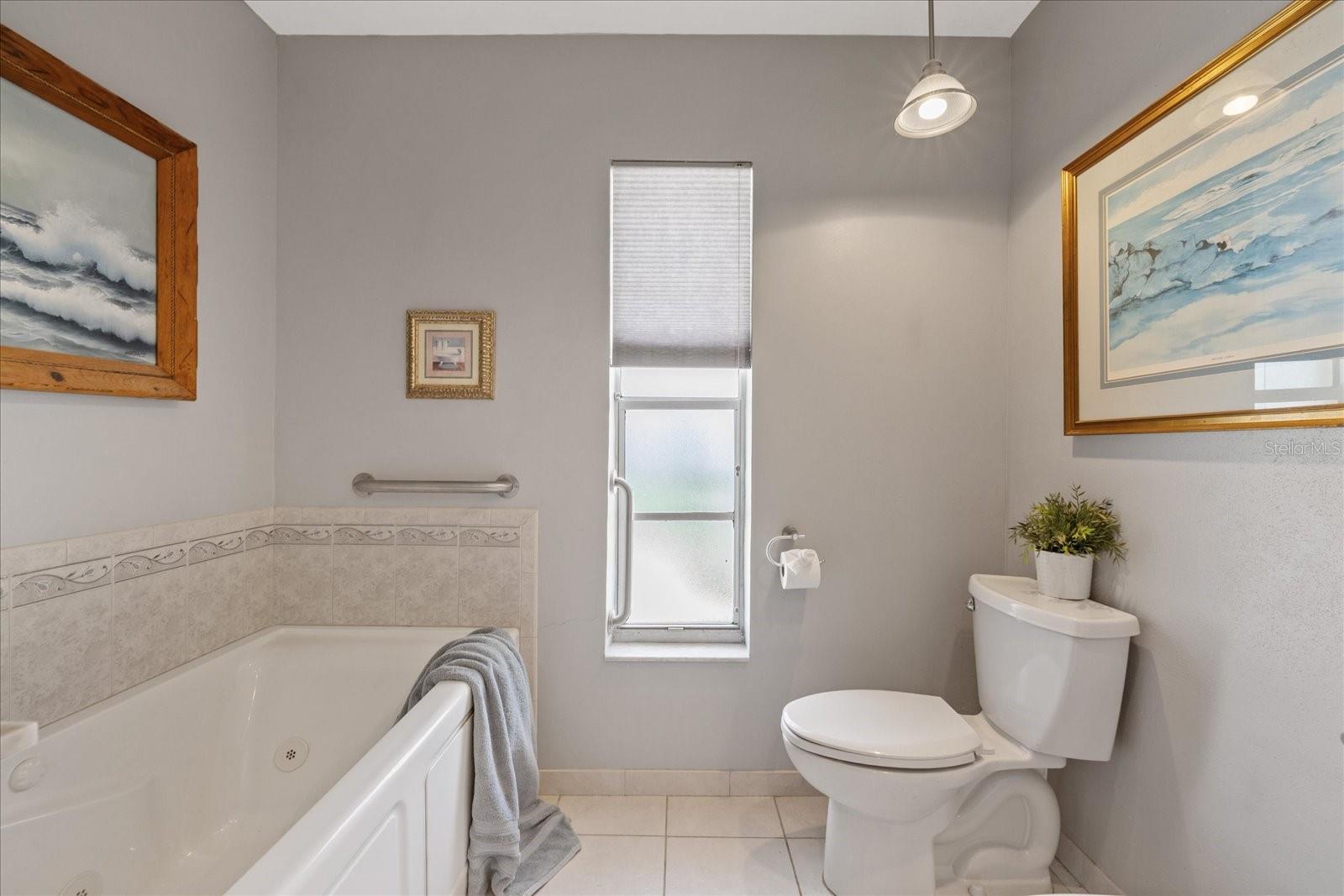 Primary ensuite with dual vanity, walk in shower, garden jetted tub, toilet and bidet.  (bidet not working)