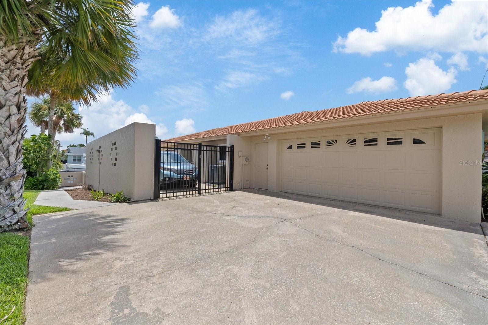 Oversized two car garage with separate gated parking pad