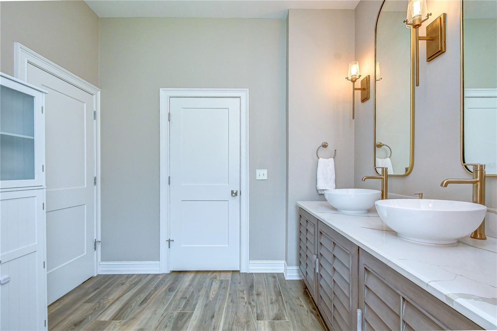 Elegant double vanity with custom mirrors.