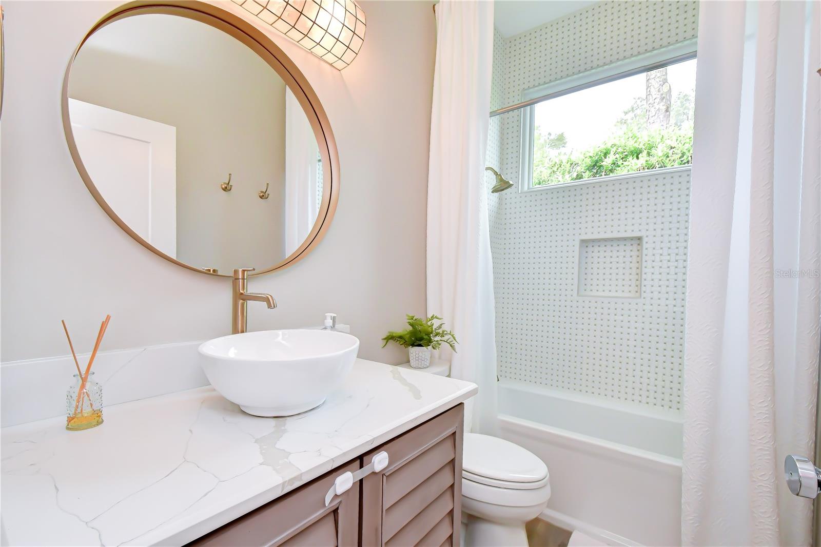 Beautifully renovated bath with custom tilework.