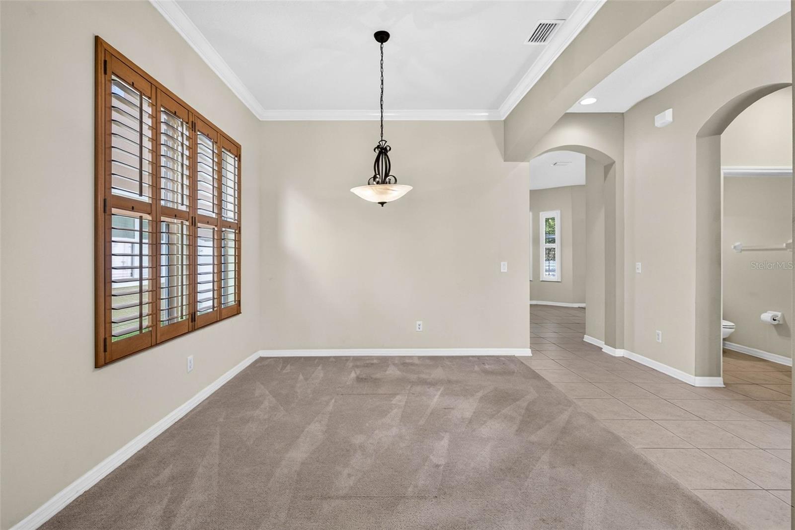 Formal dining area with plantation shutters