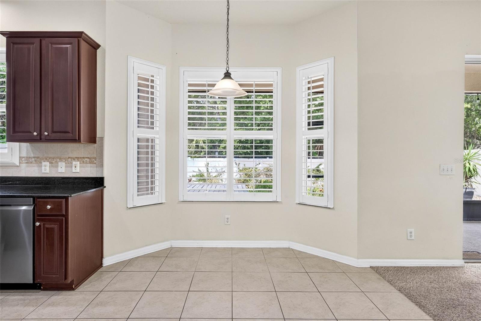 Dine in kitchen area with plantation shutters