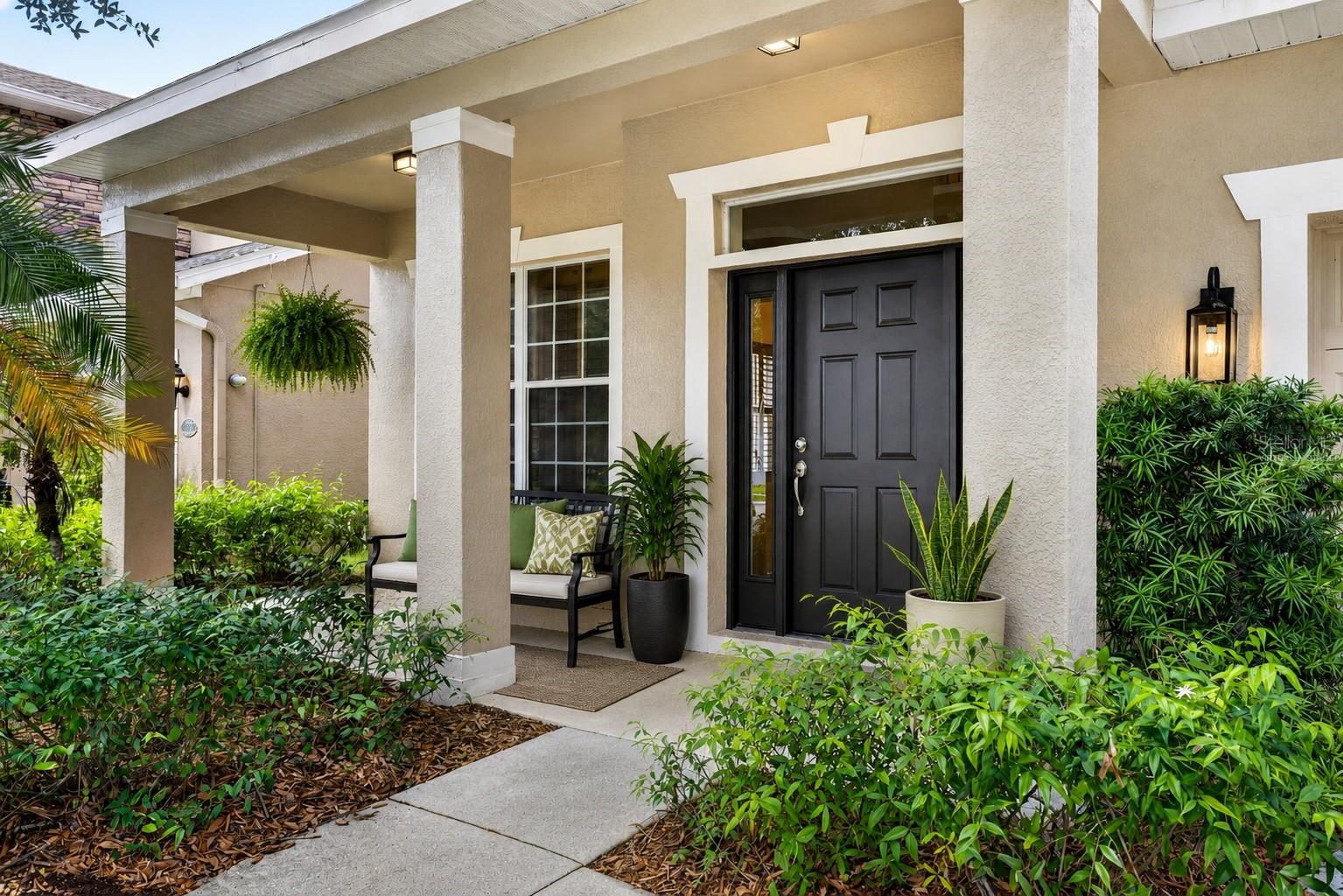 Covered front porch entry. Virtually staged