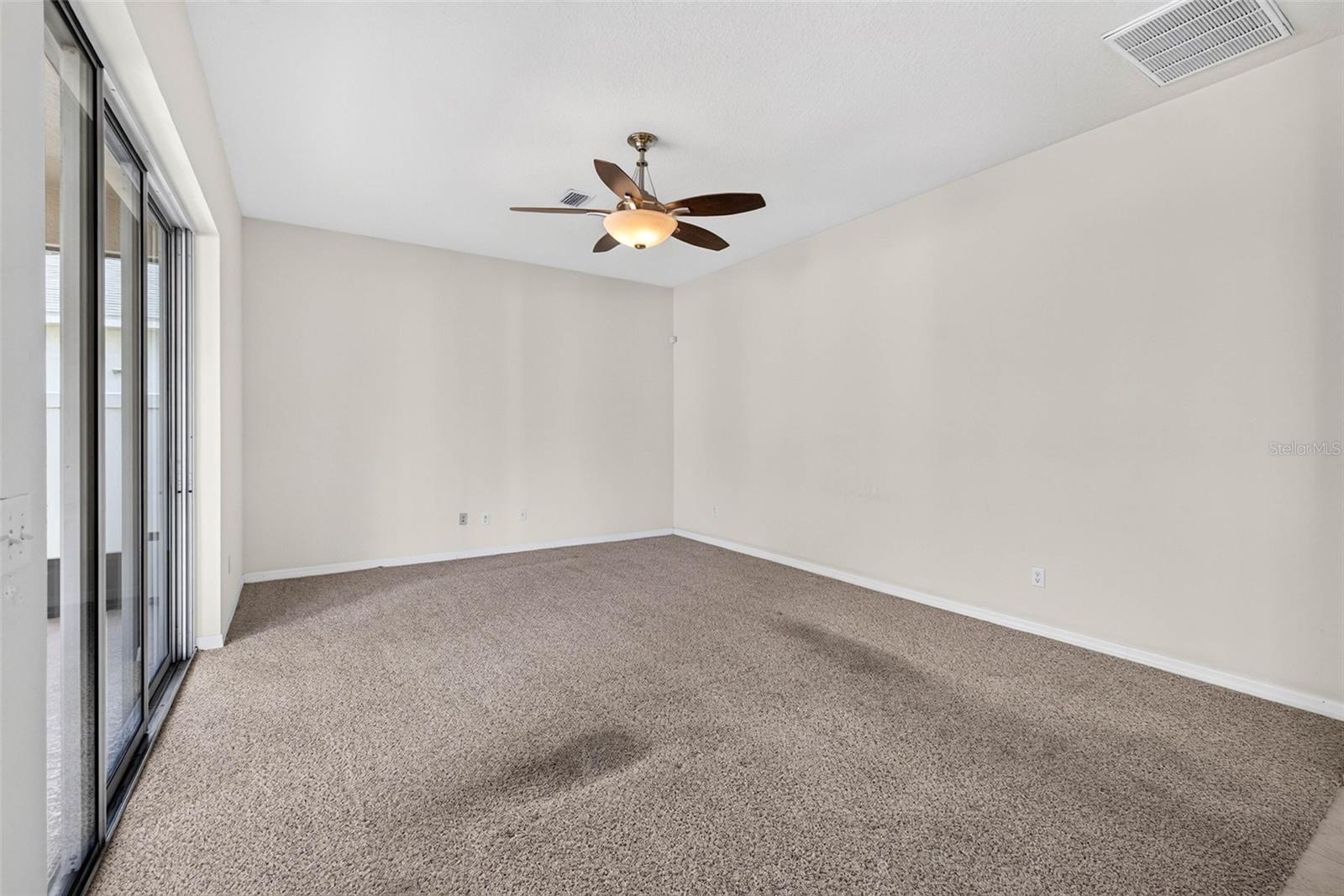 Family room with ceiling fan.
