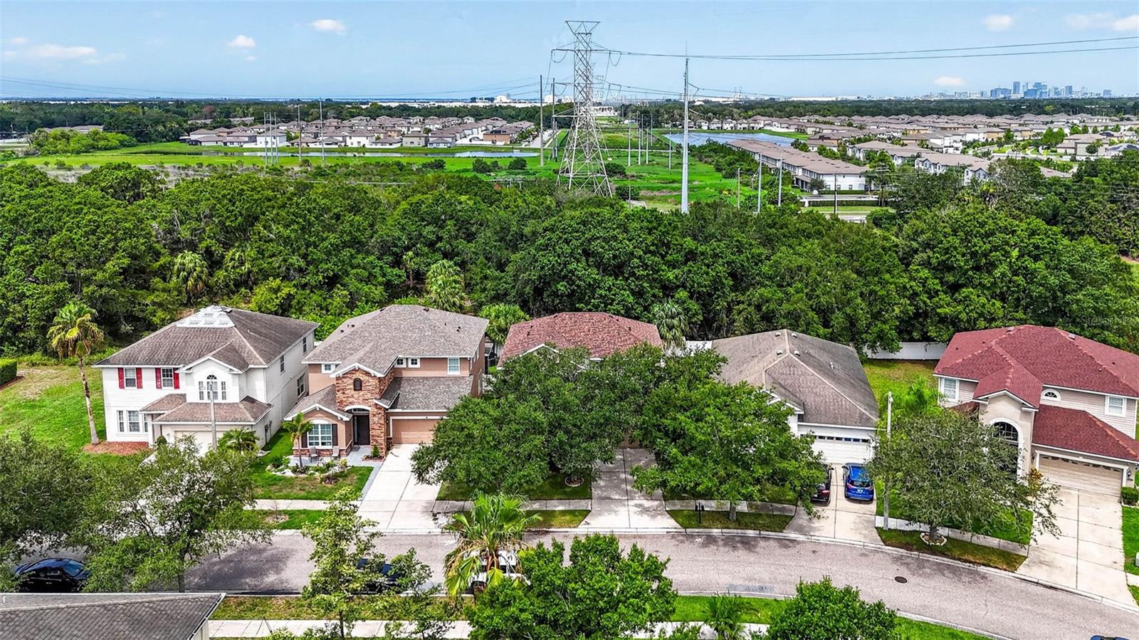 Aerial shot of house with trees in front yard and behind.