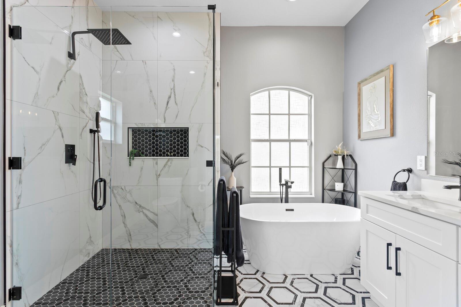 Gorgeous primary bath with frameless shower with rain head