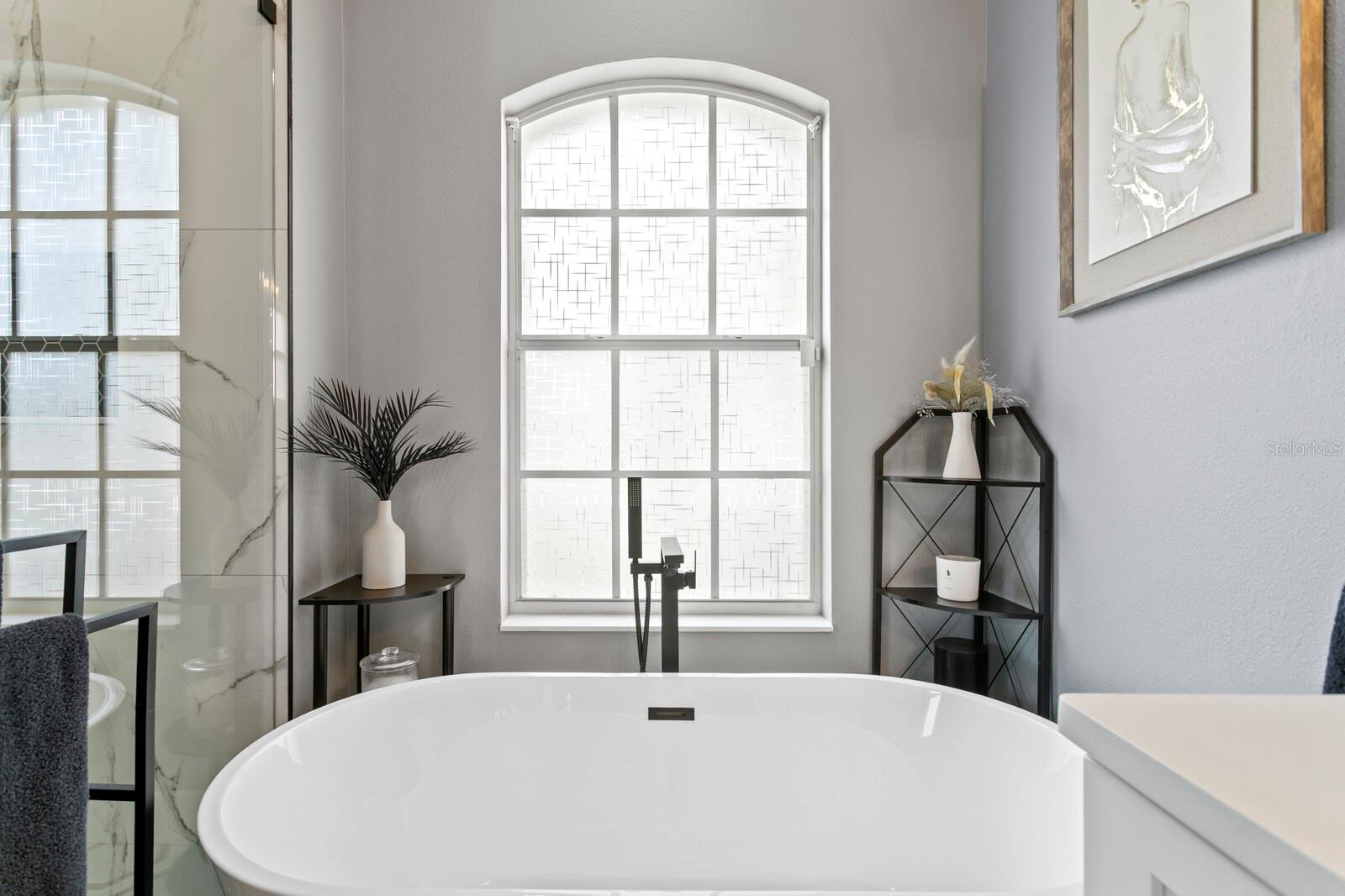 Free-standing soaking tub in primary bath