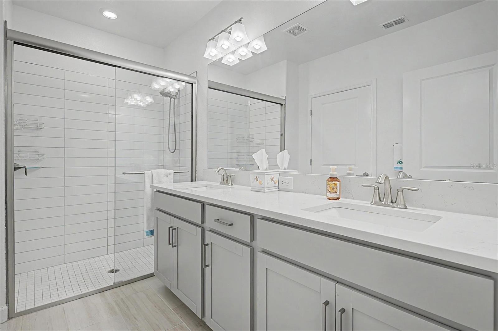 En-suite bath with quartz counter tops with dual sinks