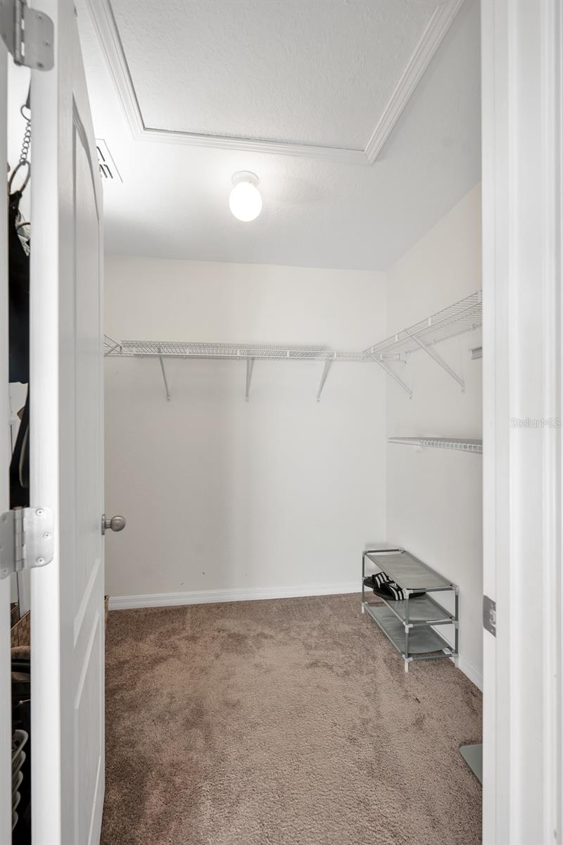 Primary bedroom walk-in closet