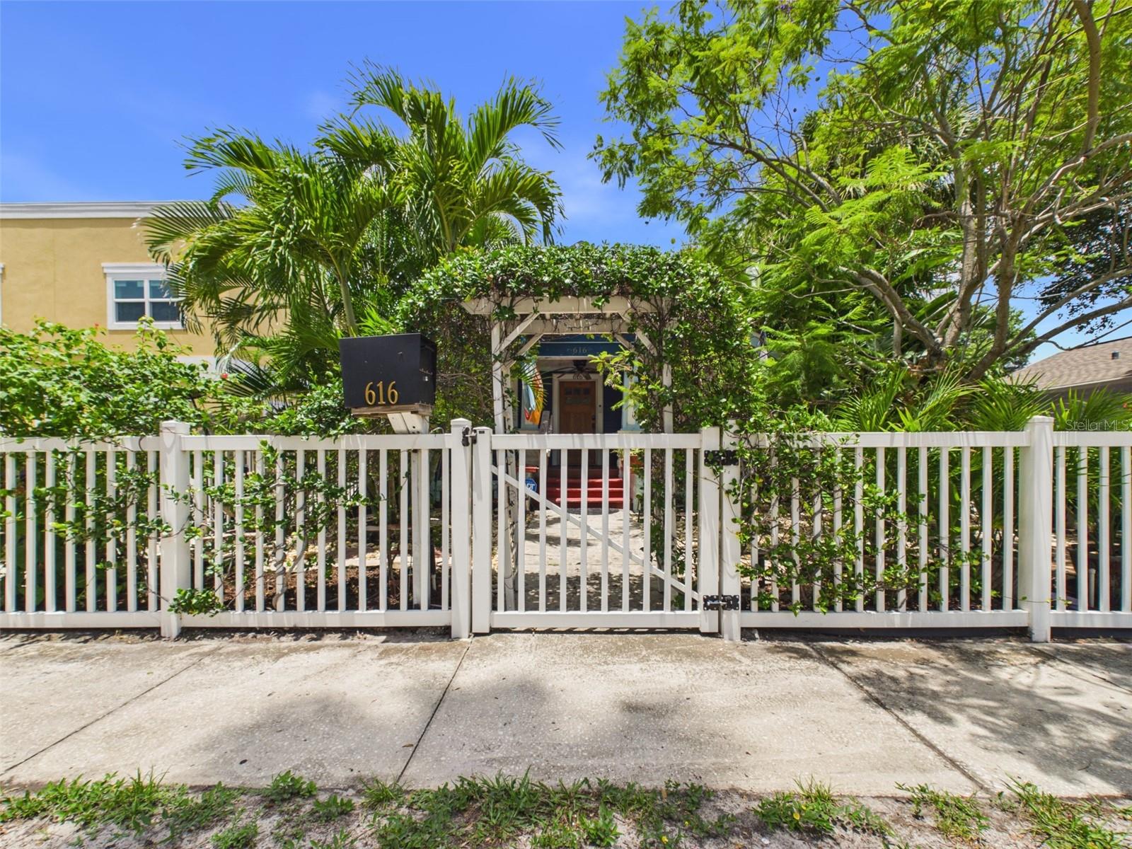 A quaint, fenced-in front entryway.