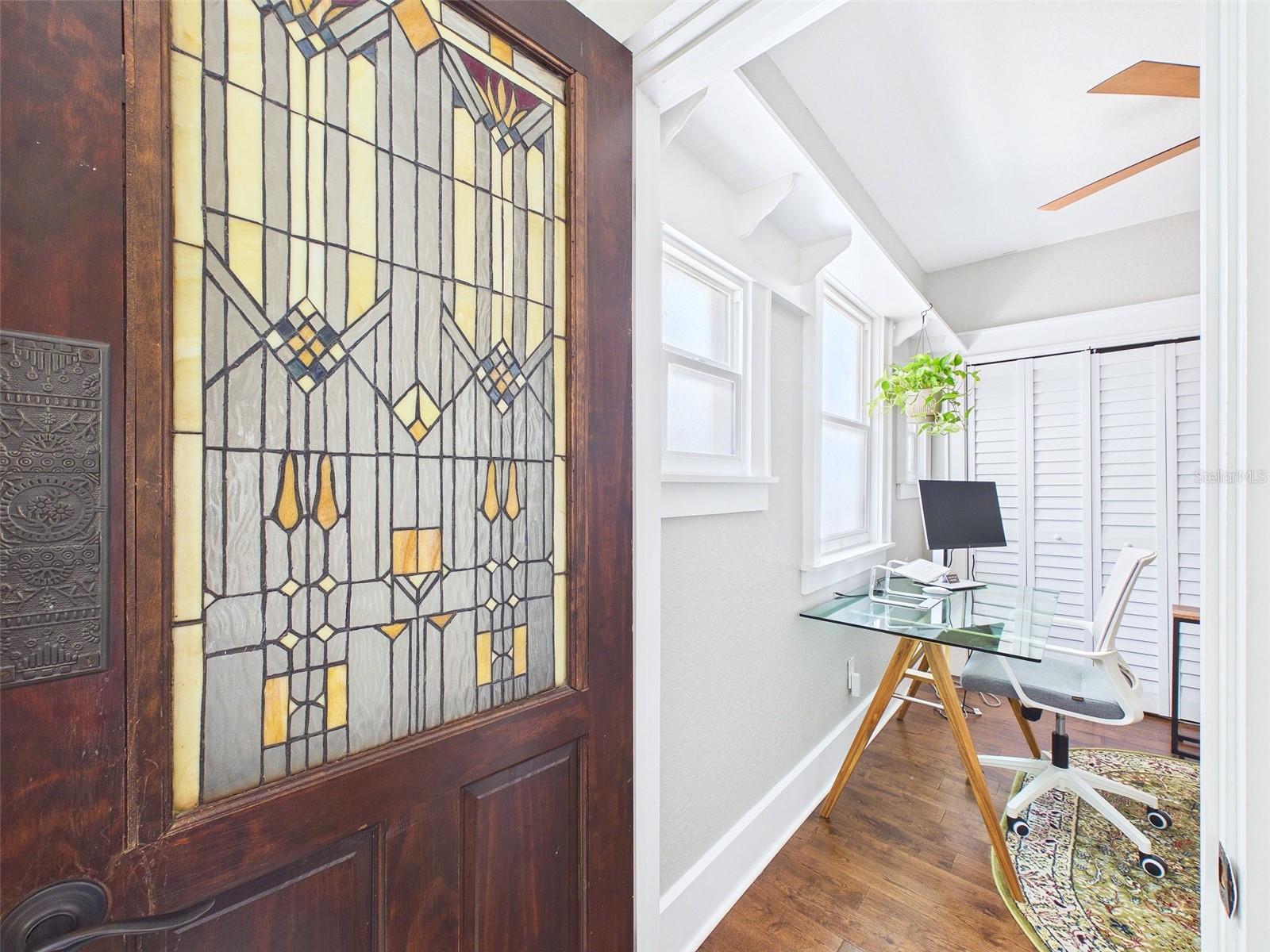 Guest bedroom with original stained-glass door